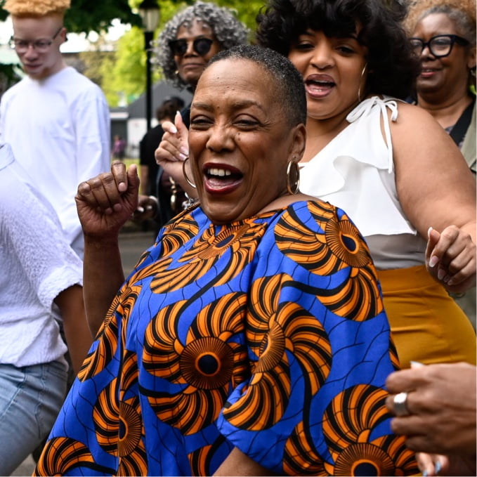 Denise laughing and dancing.