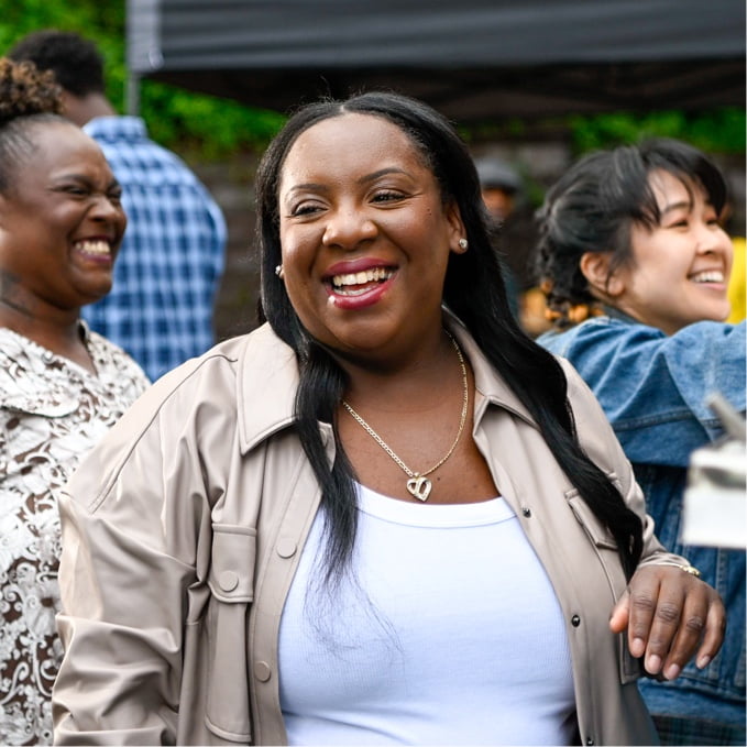 Tamera smiling among other people.